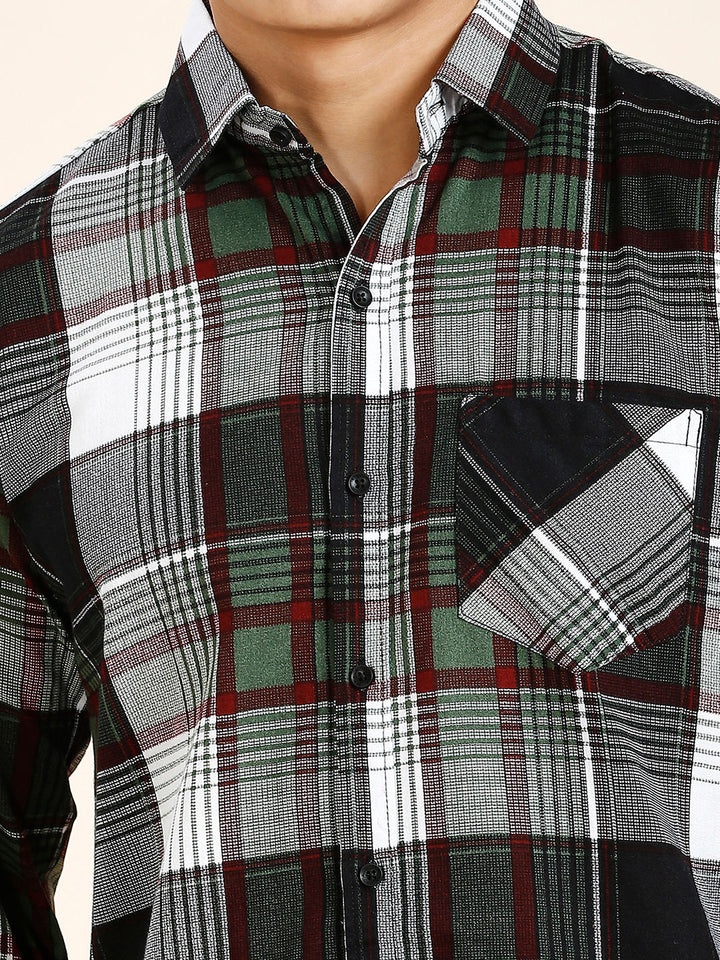 a close up of a man wearing a plaid shirt