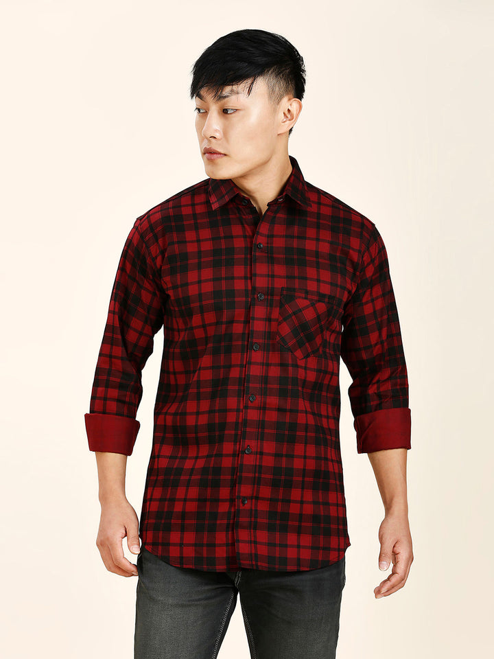 a man wearing a red and black plaid shirt