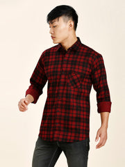 a man in a red and black plaid shirt