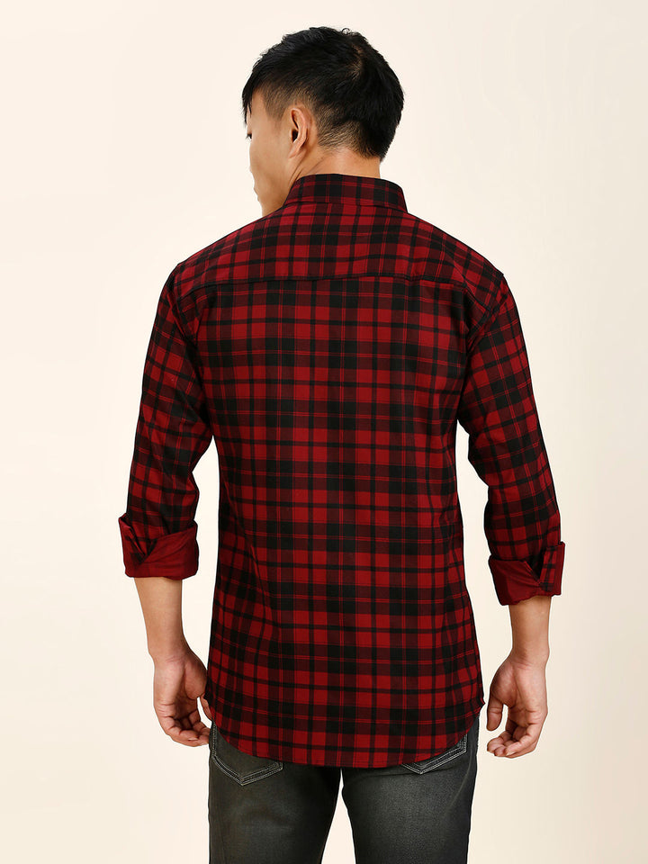 a man wearing a red and black plaid shirt