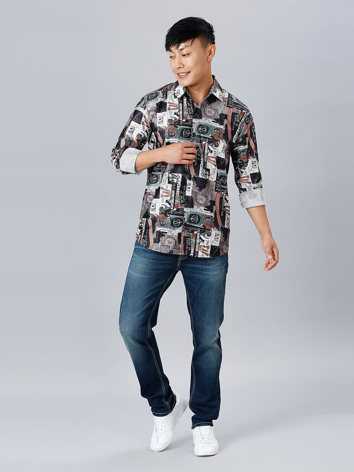 a man in a shirt and jeans poses for a picture