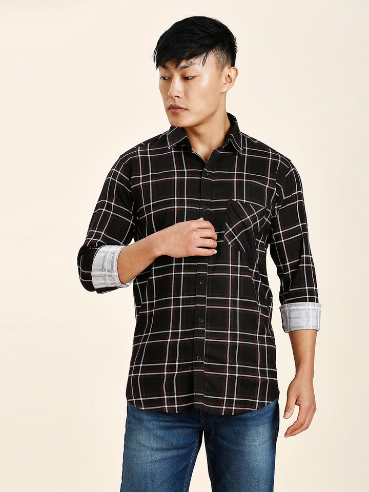 a man in a black and white checkered shirt