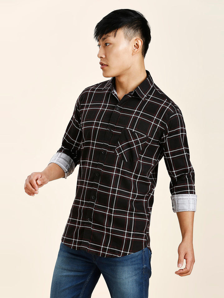 a man in a black and white checkered shirt