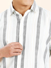 a close up of a person wearing a striped shirt