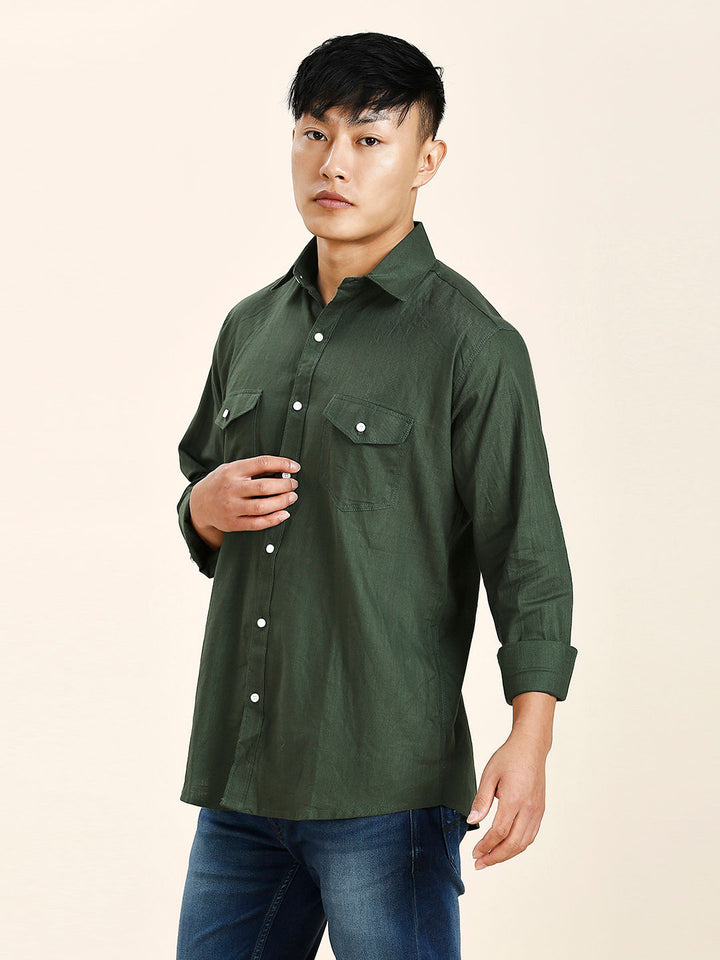 a man in a green shirt is posing for a picture