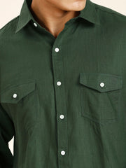 a close up of a person wearing a green shirt