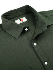 a close up of a green shirt on a white background