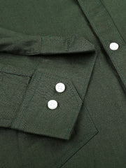 a close up of a green shirt with buttons