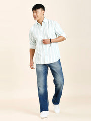 a man in a white shirt and blue jeans