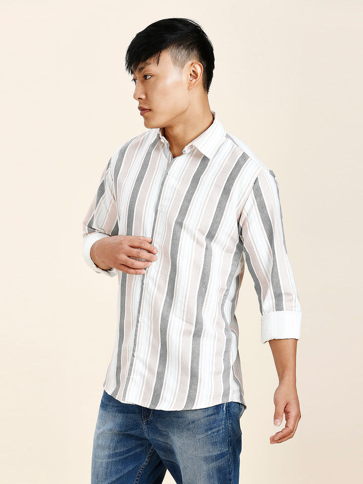 a man in a striped shirt and jeans