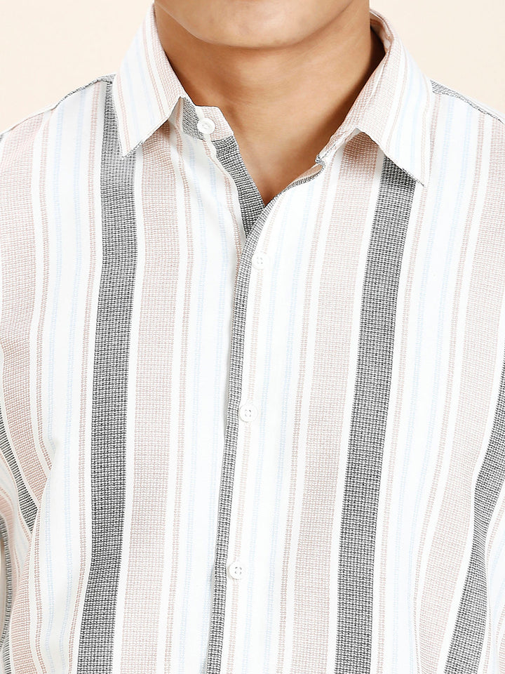 a close up of a person wearing a striped shirt