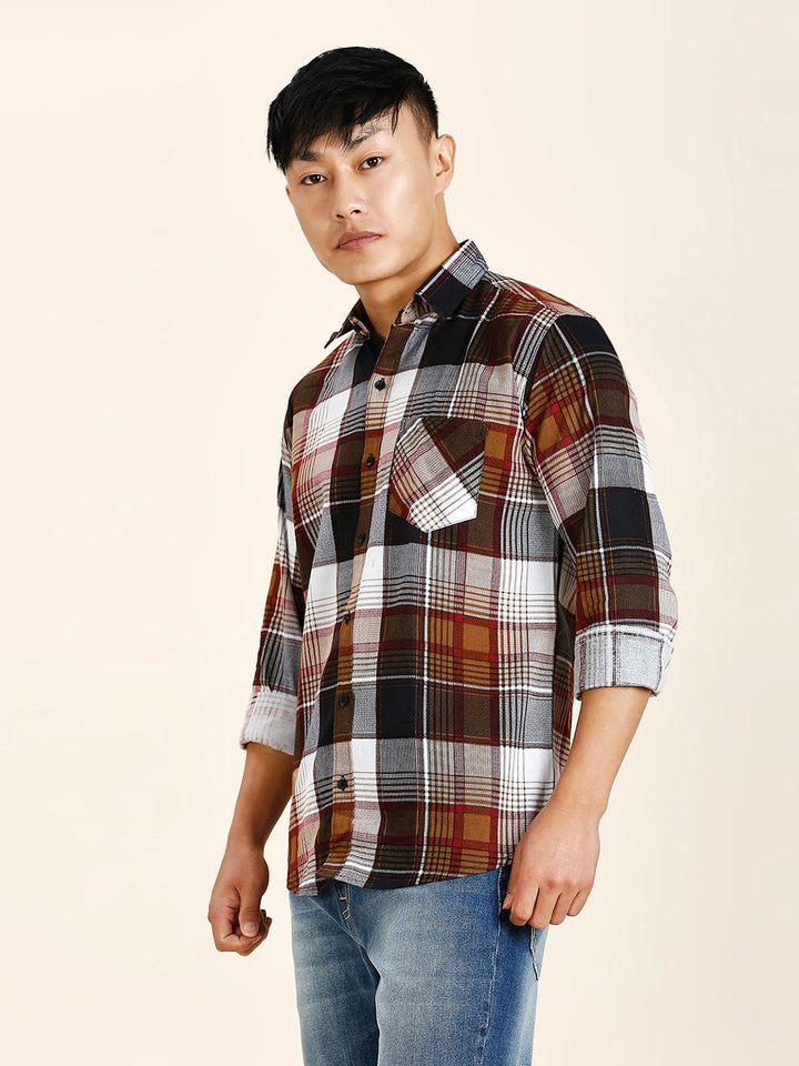 a young man in a plaid shirt poses for a picture