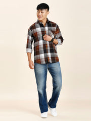 a man in a plaid shirt and jeans