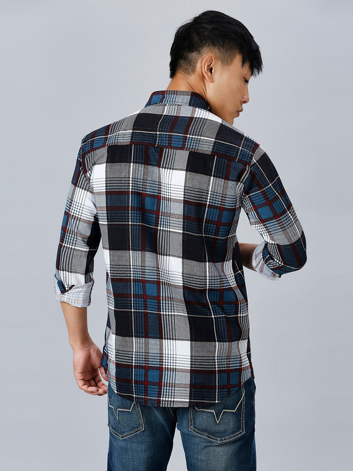 a man wearing a plaid shirt and jeans