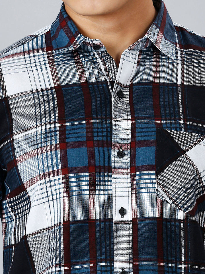 a close up of a man wearing a plaid shirt