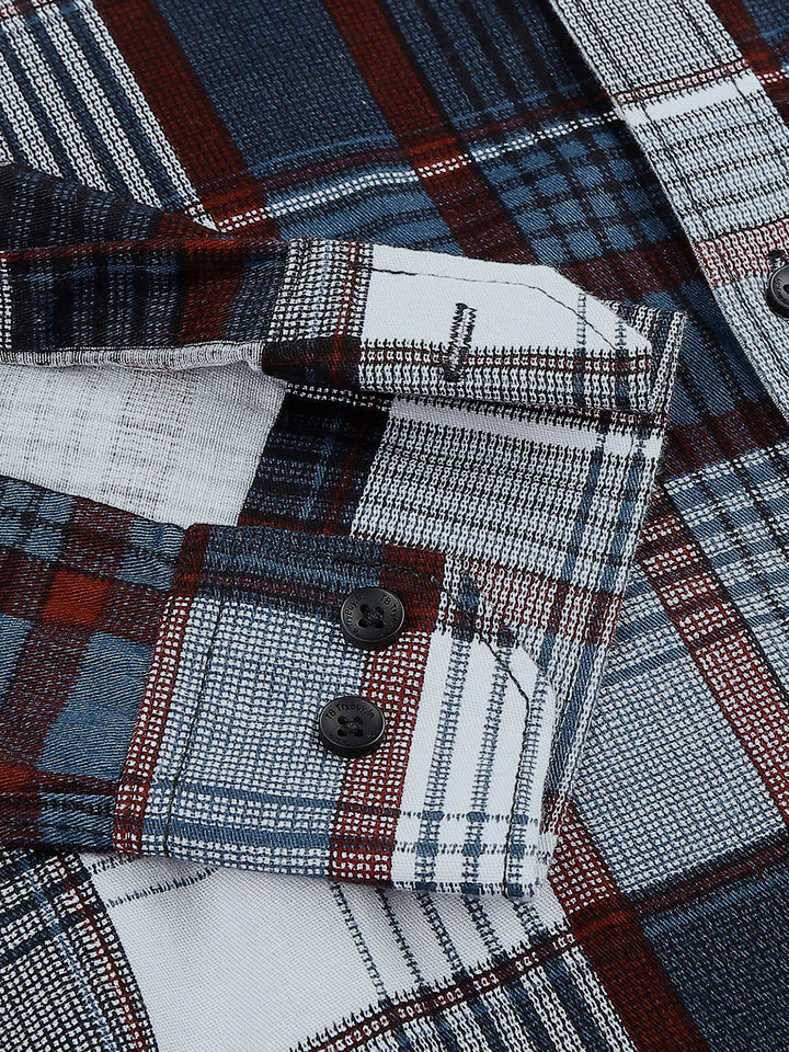 a close up of a plaid shirt with buttons