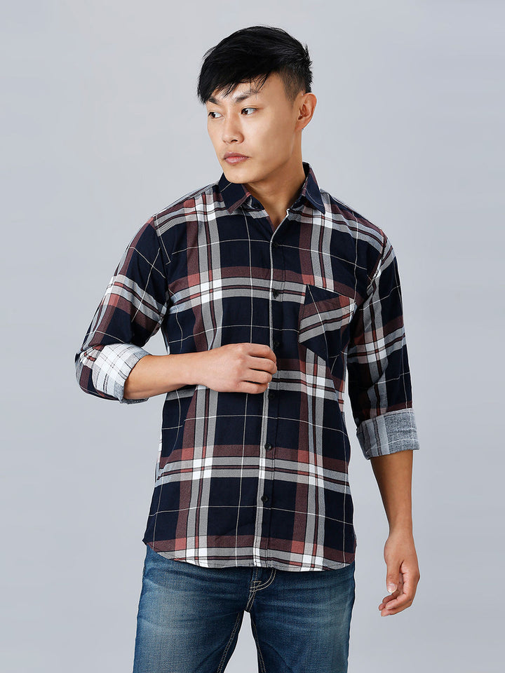 a man in a plaid shirt is posing for a picture