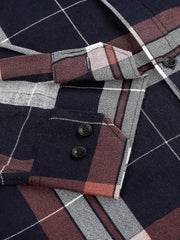 a close up of a plaid shirt with buttons