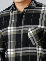 a man wearing a black and grey plaid shirt