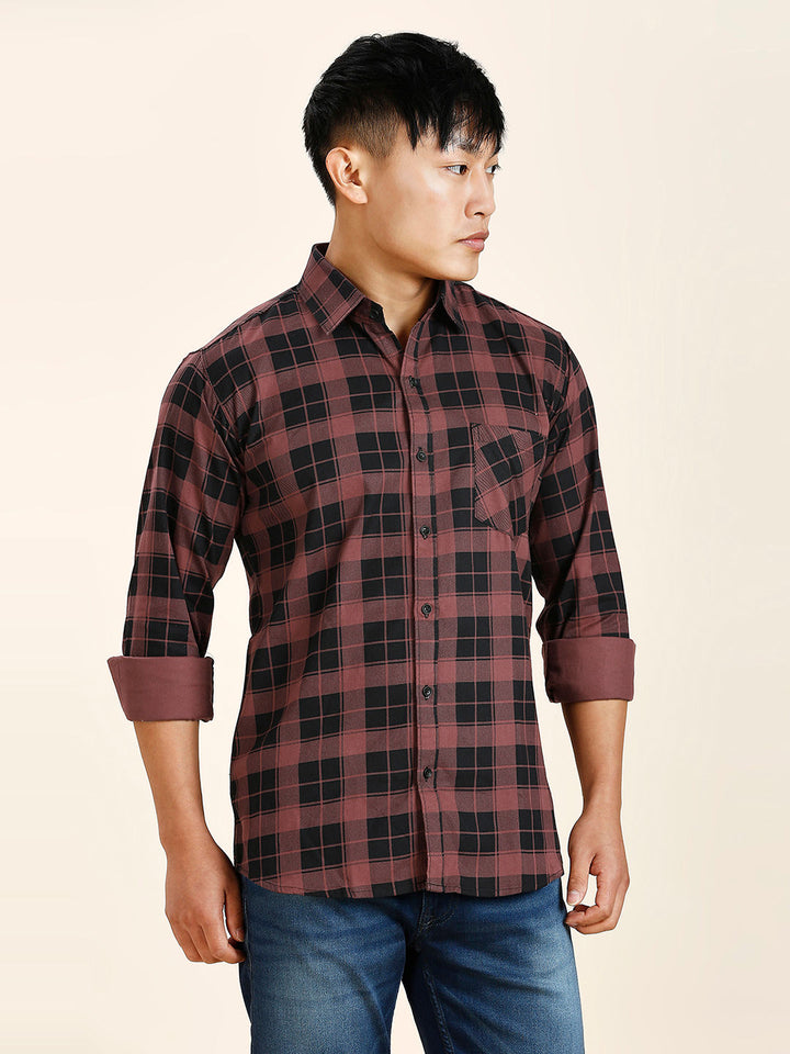 a man in a red and black plaid shirt