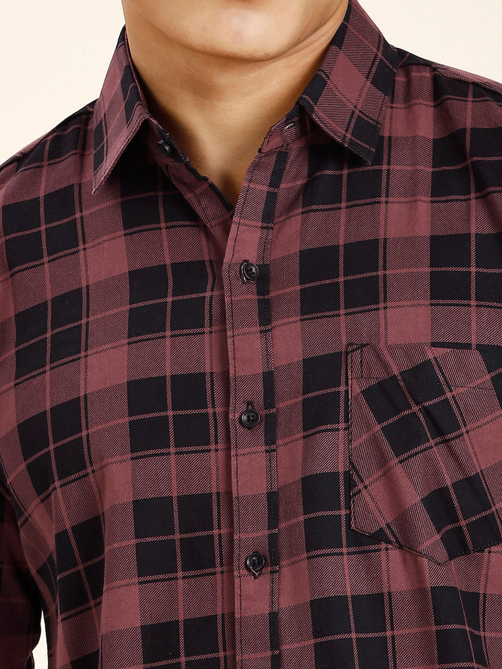 a man wearing a red and black plaid shirt