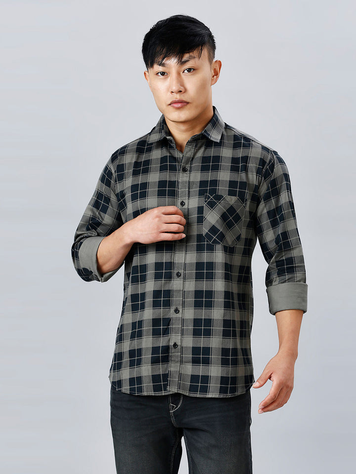 a young man in a black and grey checkered shirt