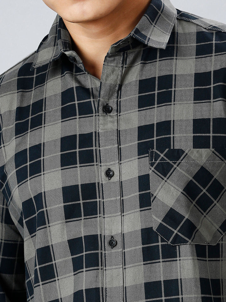 a man wearing a black and grey checkered shirt