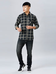 a young man in a black and grey checkered shirt