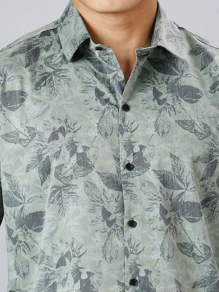 a man wearing a shirt with a flower pattern