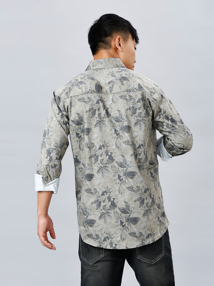 a man wearing a shirt with a flower pattern on it