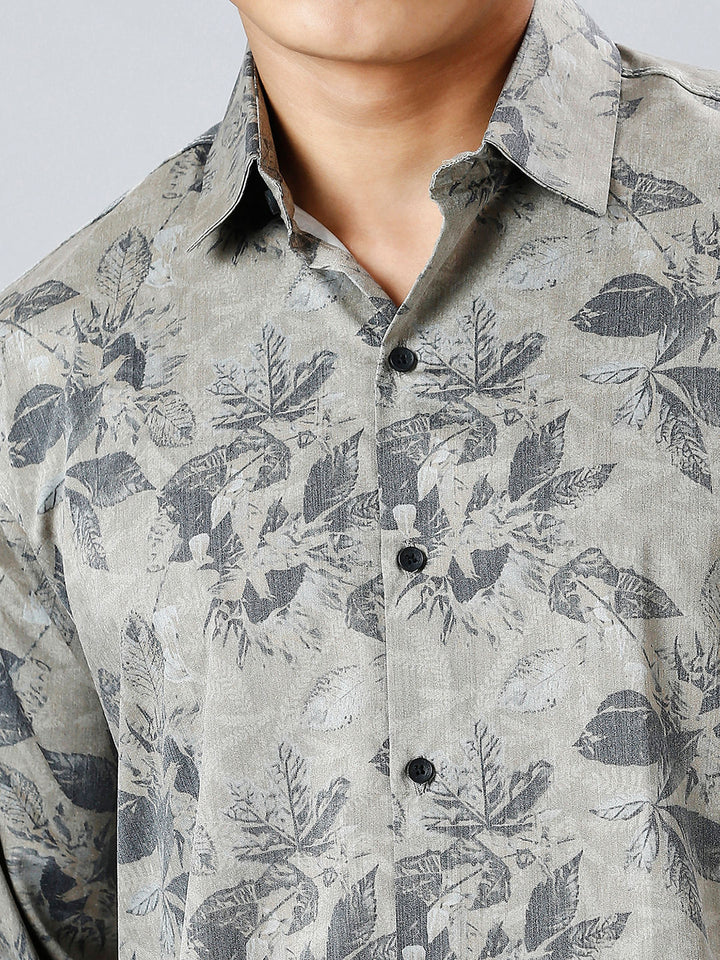 a man wearing a shirt with a flower pattern