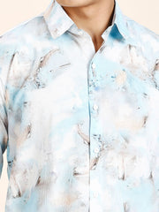 a man wearing a light blue shirt with a bird pattern on it