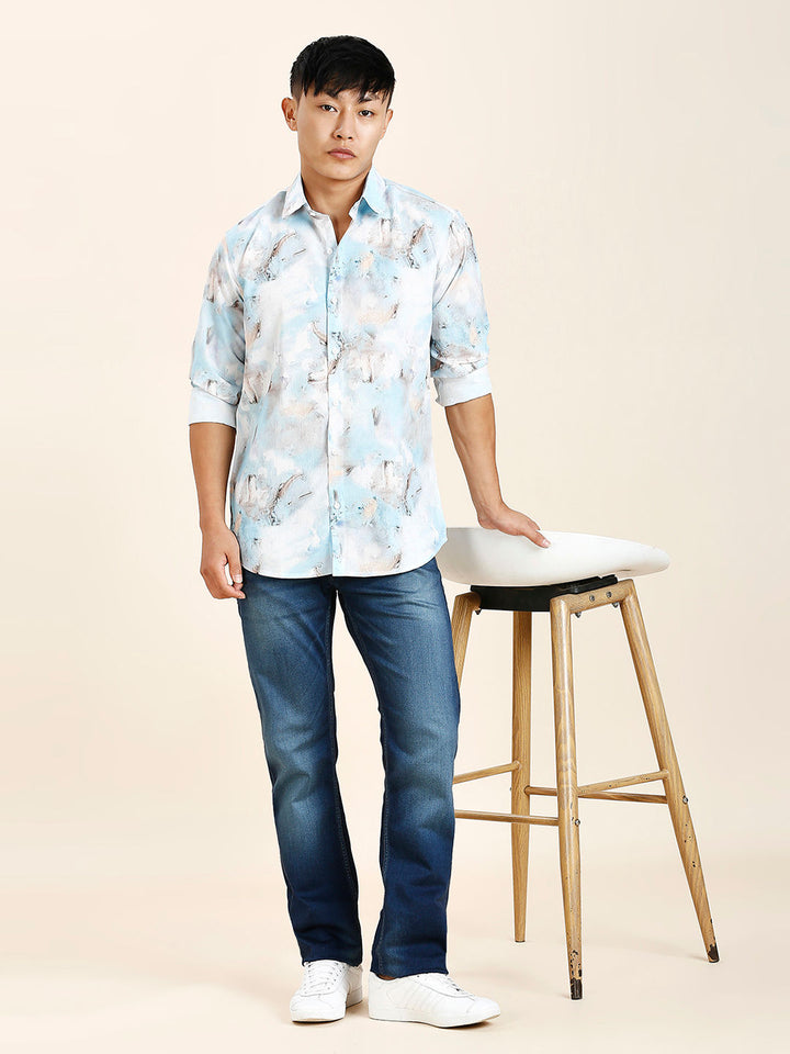 a young man standing next to a stool