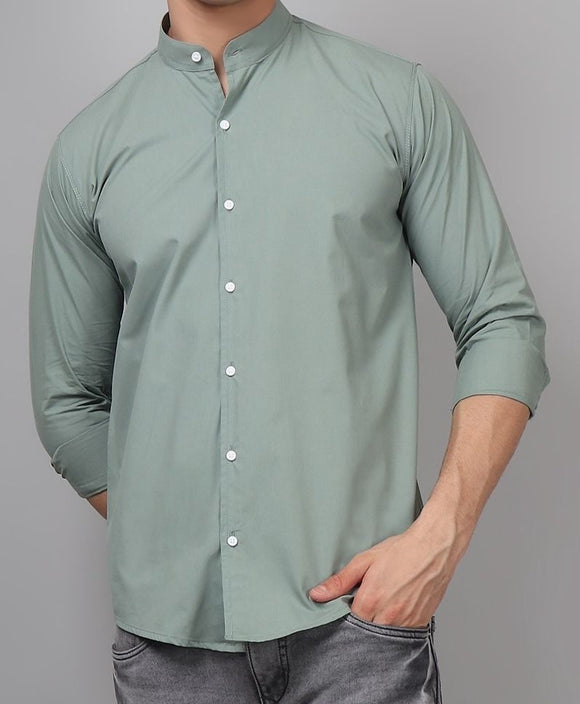 a man wearing a green shirt and jeans