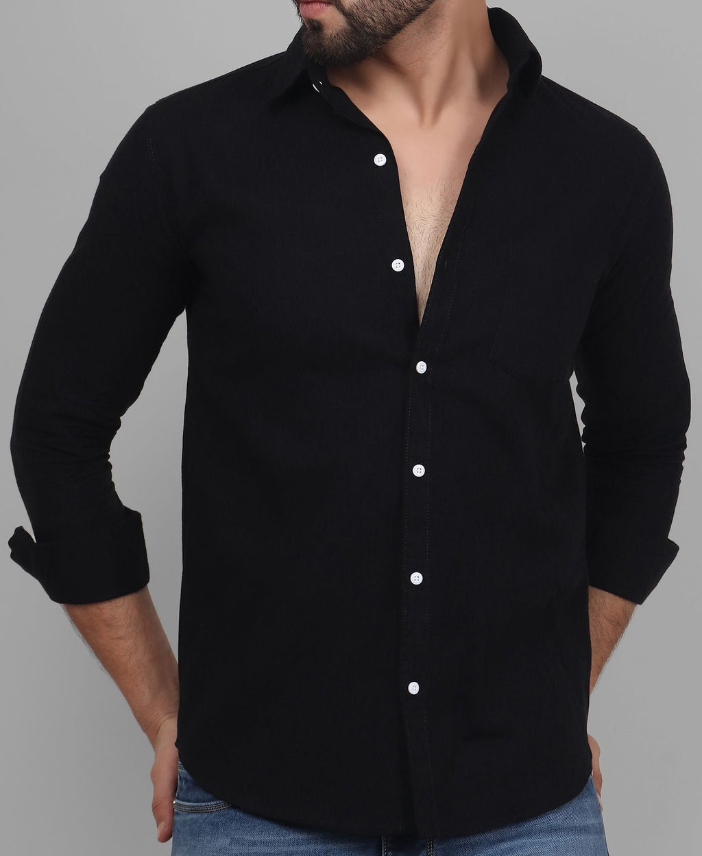 a man wearing a black shirt and jeans