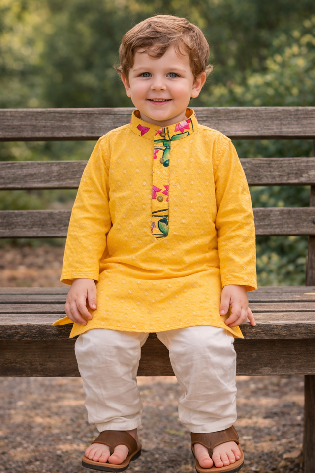Yellow kids kurta size 20 sitting pose with white pyjama