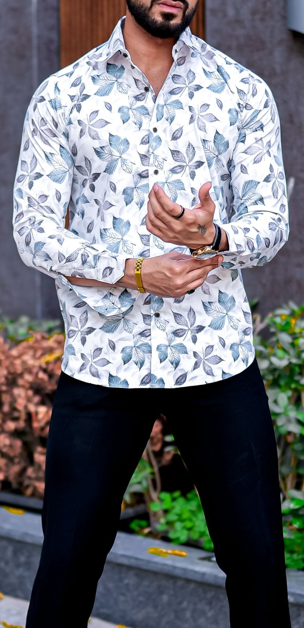 a man wearing a white shirt and black pants