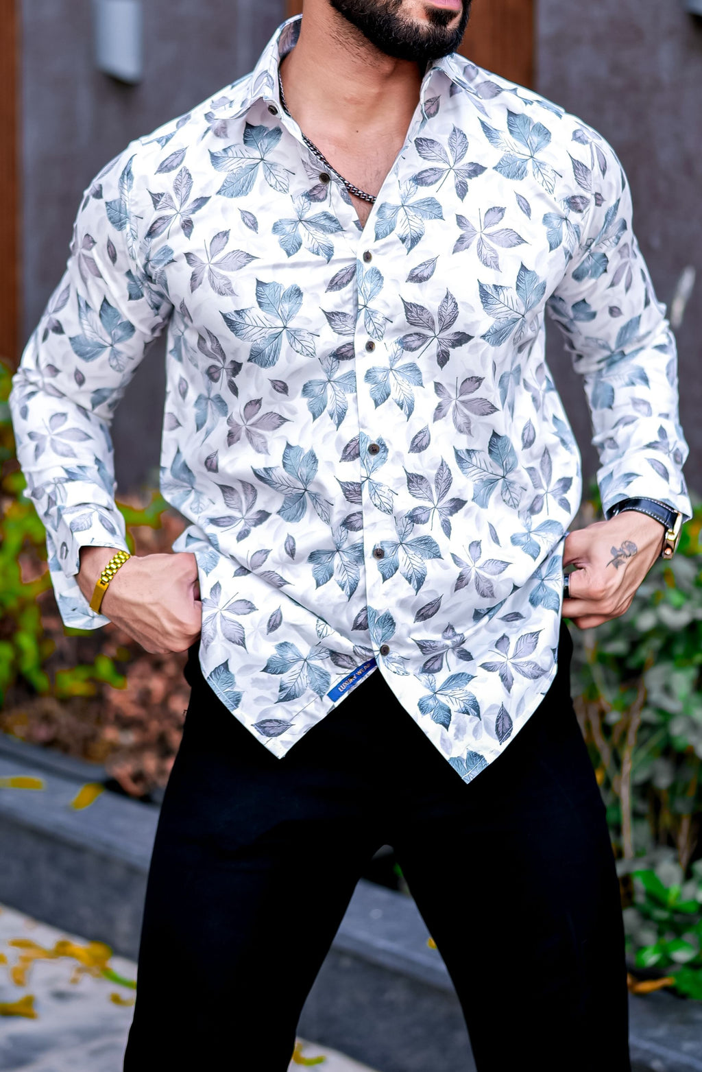 a man wearing a white shirt and black pants