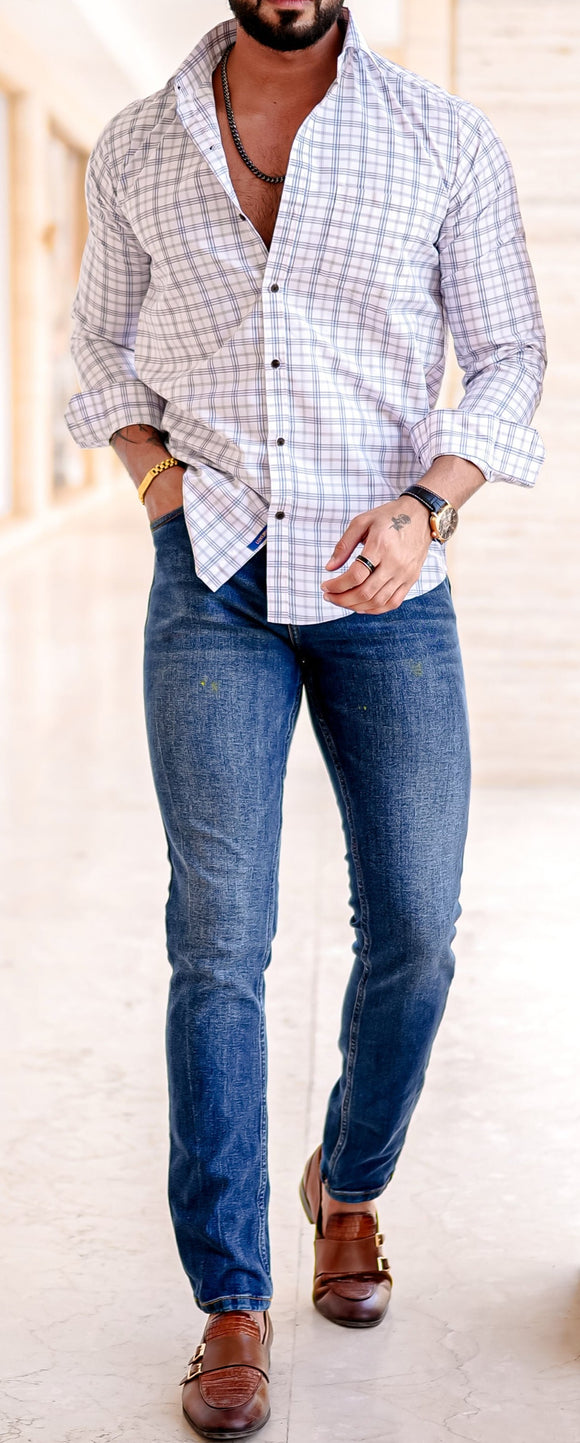 a man standing in a hallway with his hands in his pockets