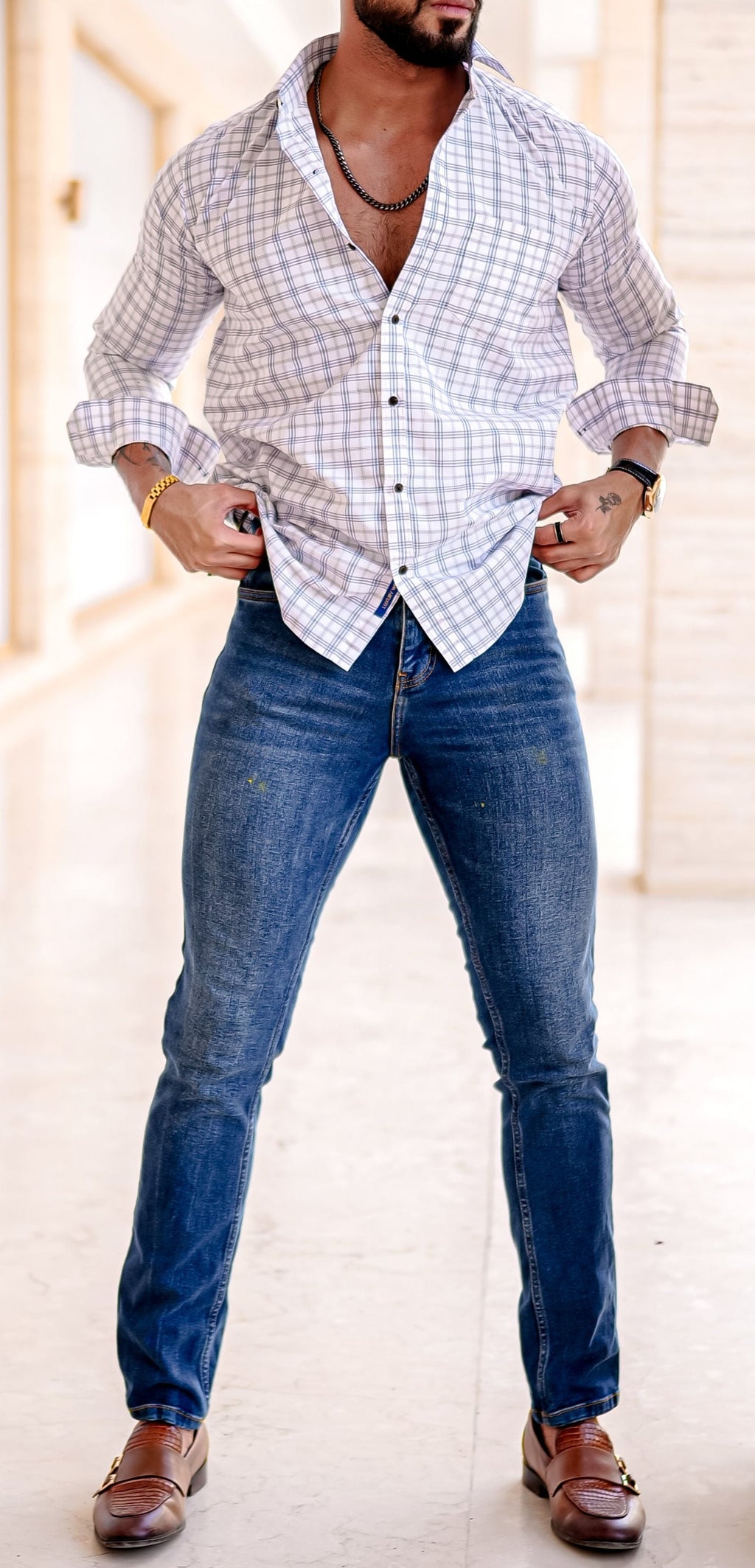 a man standing in a room with his hands on his hips