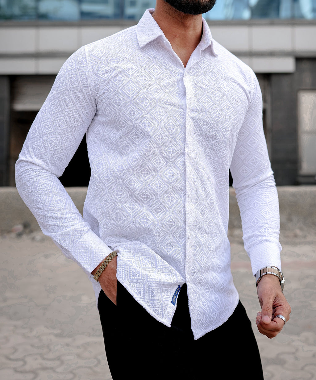 a man wearing a white shirt and black pants