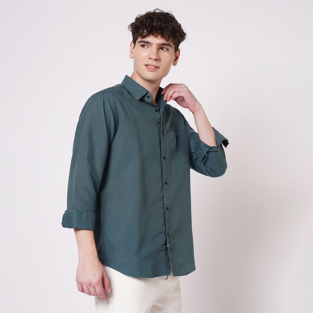Men's teal green solid shirt styled with white trousers