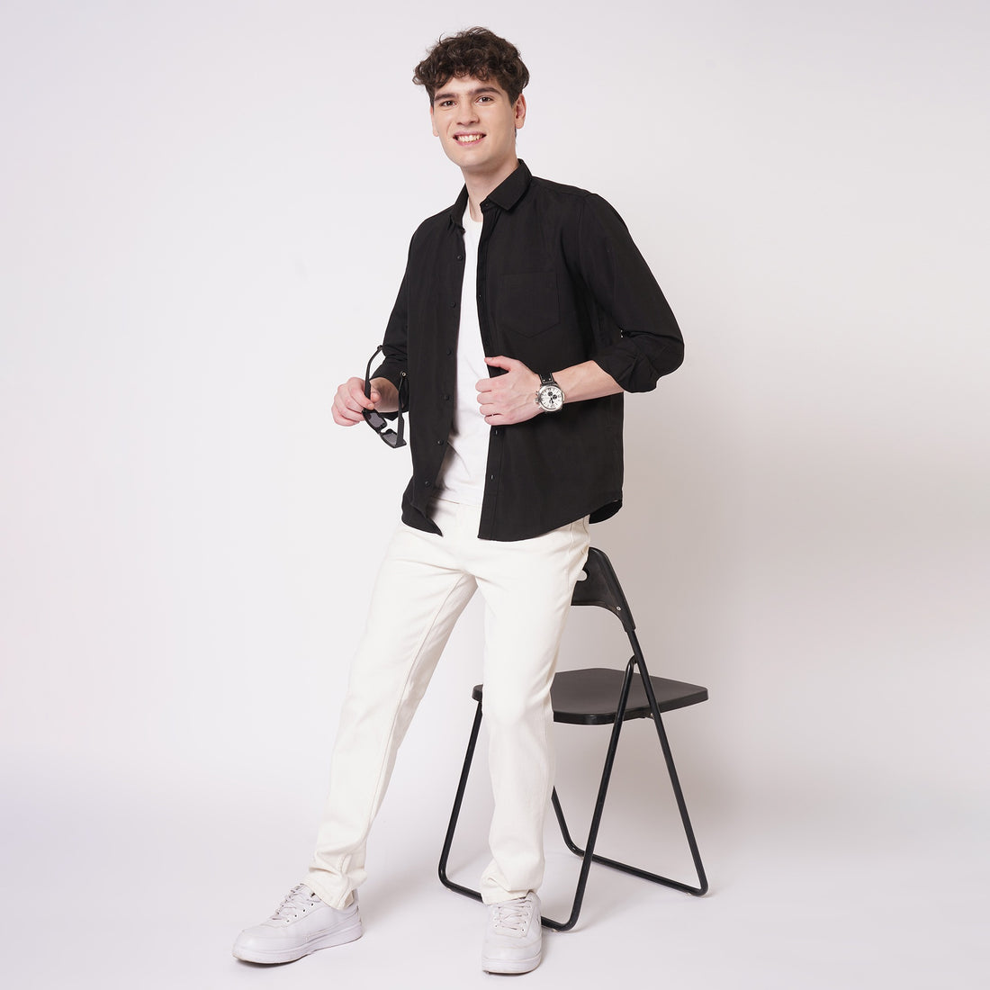 Black cotton full sleeve shirt for men styled with white trousers