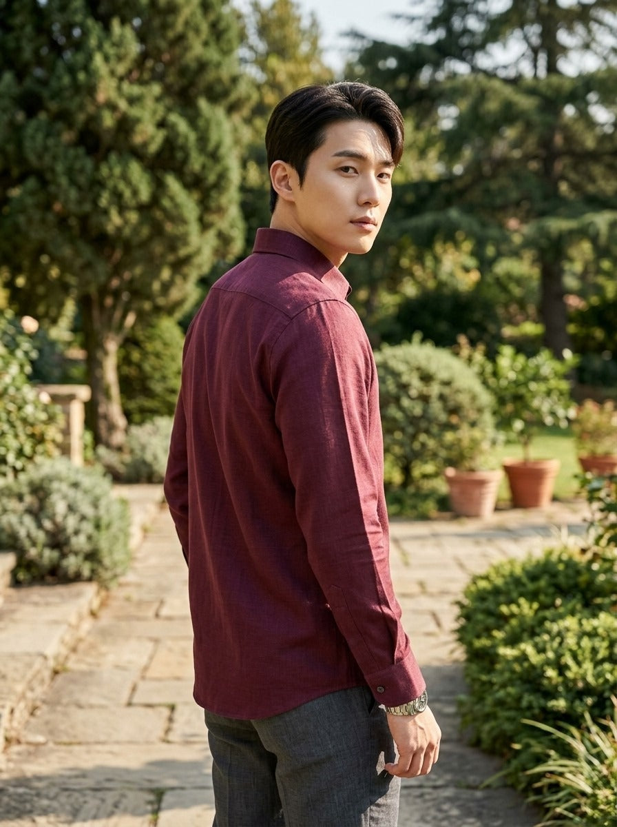 TRYBUY.IN TB_21190 burgundy cotton-linen shirt, rear three-quarter garden view showing the back yoke, textured fabric and buttoned cuff.