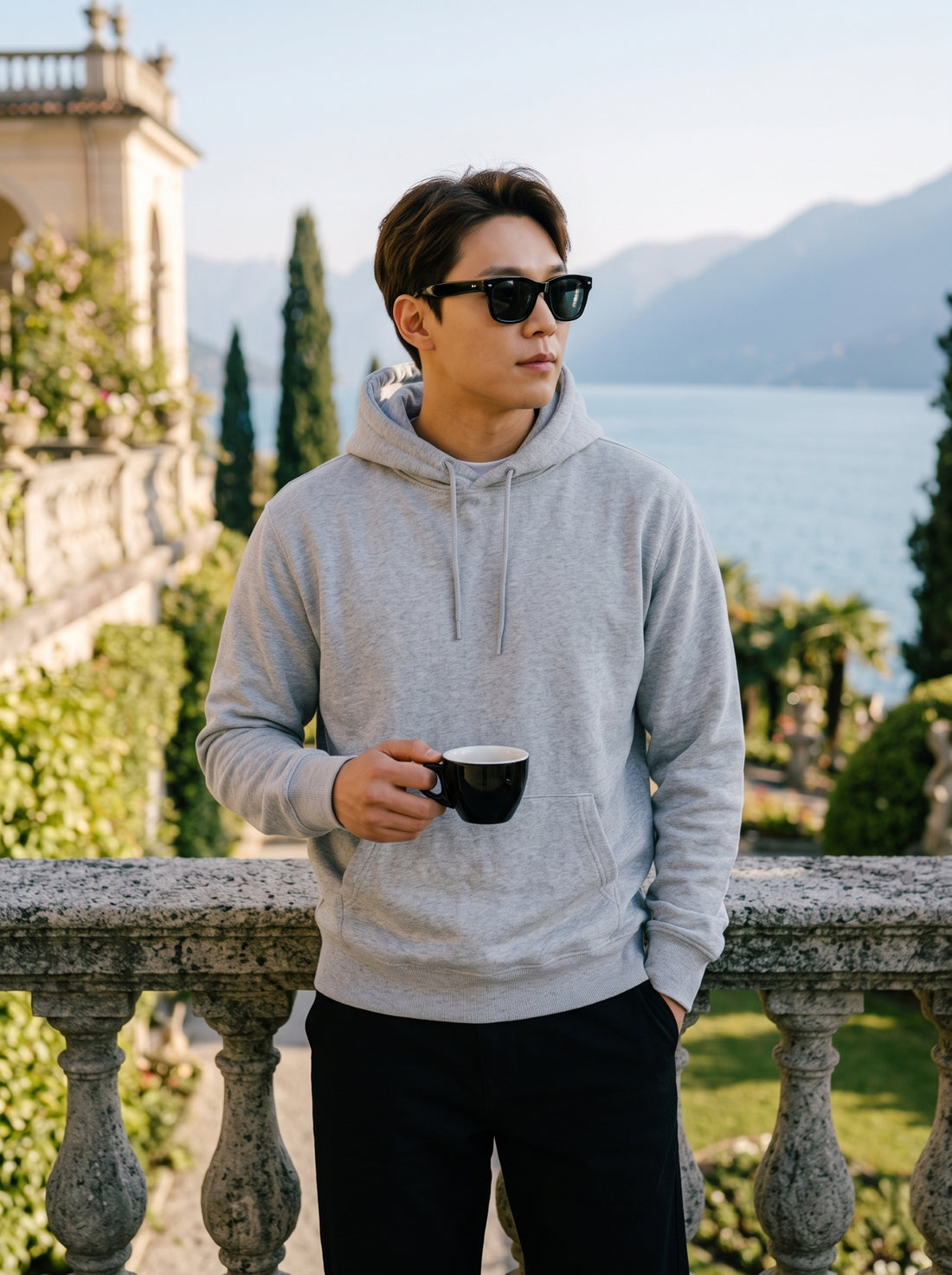 
Men's light grey cotton pullover hoodie, front mid-length lifestyle view
