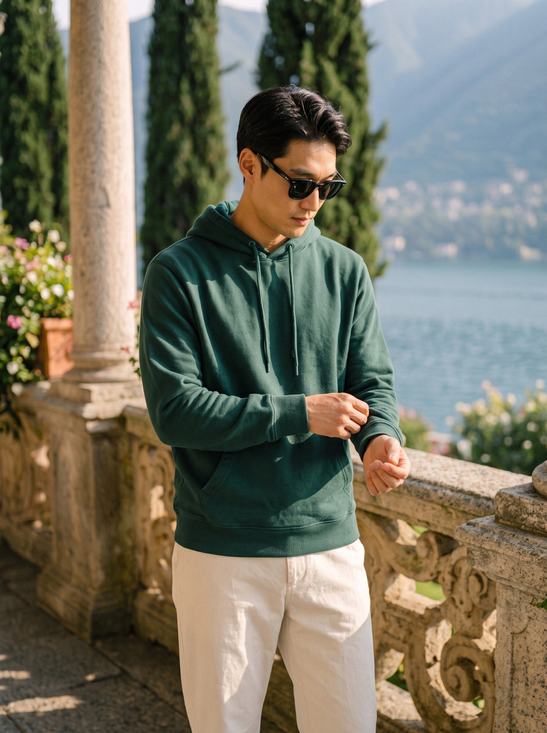 
Men's forest green cotton pullover hoodie, front cuff detail lifestyle view
