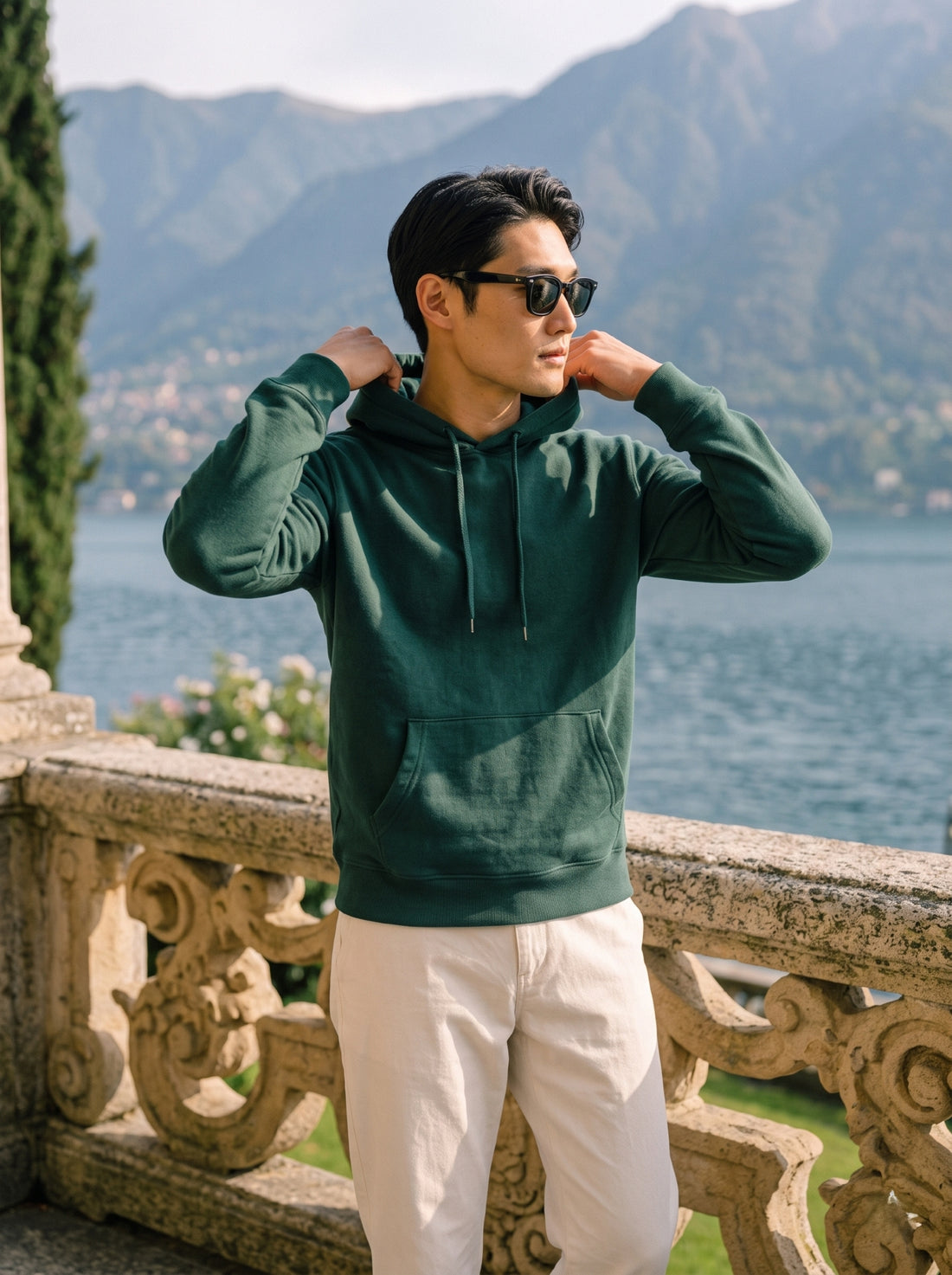 
Men's forest green cotton pullover hoodie, front hood detail lifestyle view
