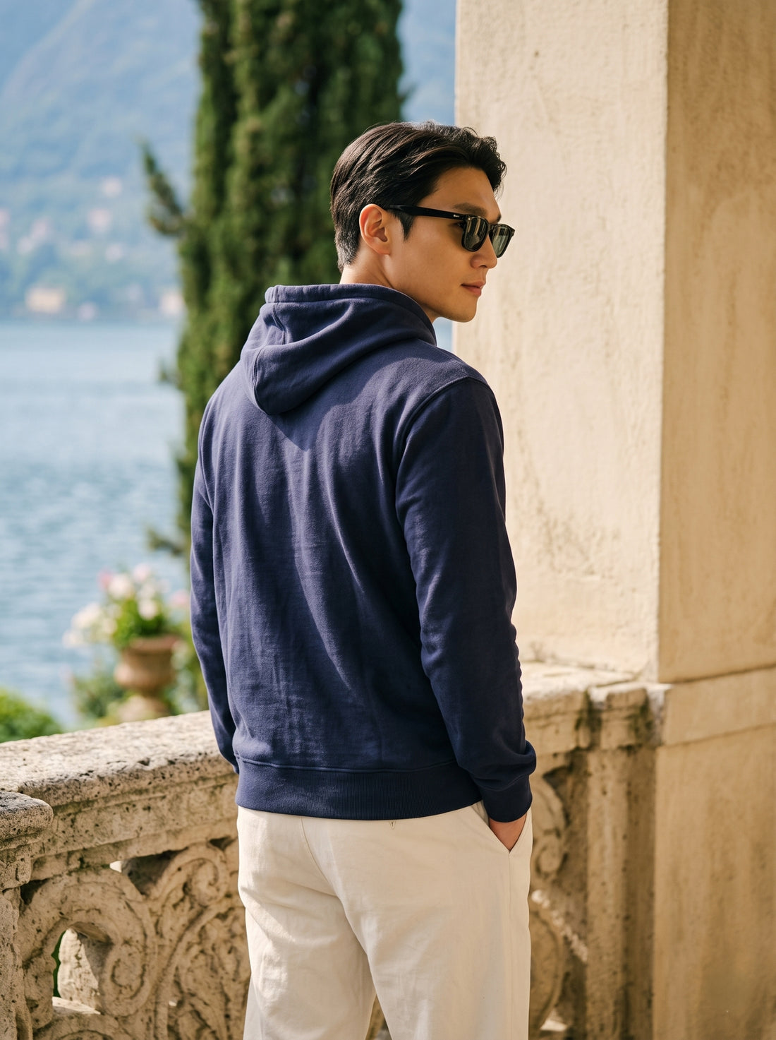 
Men's navy blue cotton pullover hoodie, rear three-quarter view
