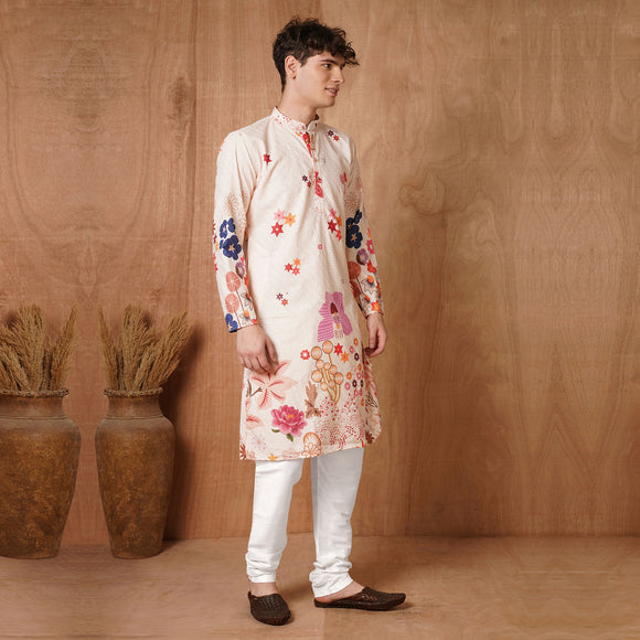 Men's Multicolor Floral Printed Kurta styled with white churidar, showcasing vibrant ethnic design for weddings and festivals.