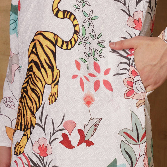 Close-up of Chikankari kurta fabric showcasing intricate tiger and floral print details, perfect for ethnic festive fashion.